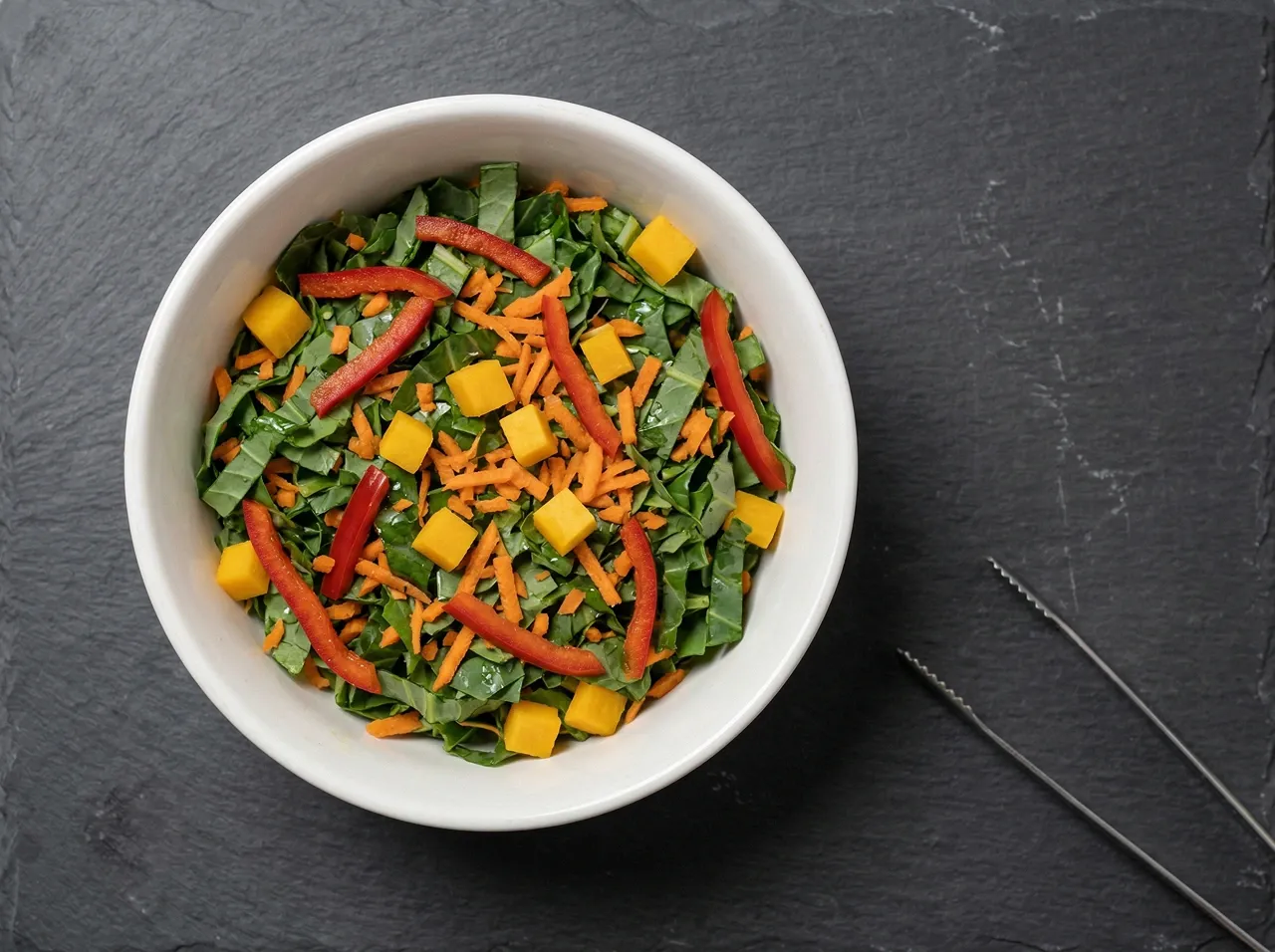 Bearded dragon salad bowl with chopped collard greens, grated carrot, red bell pepper, and butternut squash cubes
